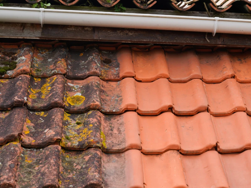 A roofer carrying out quality restoration work on a tiled roof