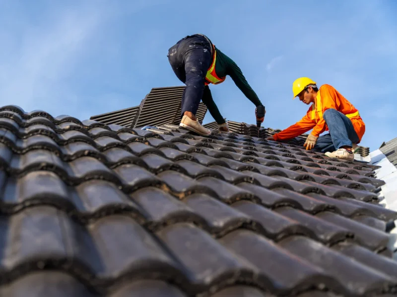 Roofer carrying out a tiled roof repair